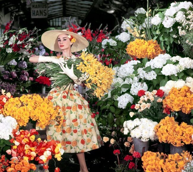 audrey hepburn holding flowers in a market
