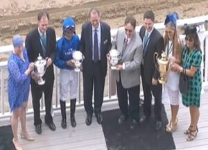 Ogden Phipps presentation Polly Singer clients in the Winner's Circle at the Belmont.